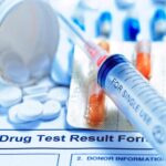 Drug test result form, pills, and syringe