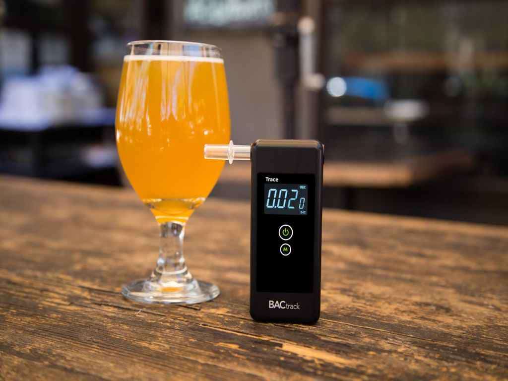 BACtrack Trace Pro breathalyzer with an alcoholic drink