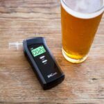 Breathalyser and a glass of beer on the table