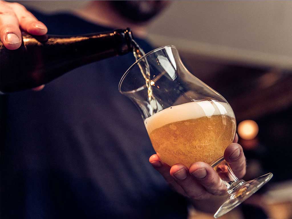 A man pouring beer into a glass