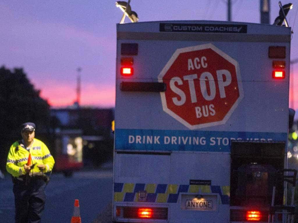 A drink driving stop sign with a police officer