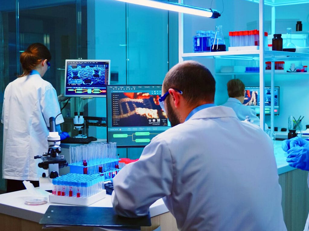 Three personnel working in a laboratory