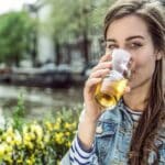 A woman drinking alcohol outside