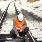 A man operator working in a railway