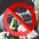 Prohibited sign on a person opening a bottle of alcohol behind the wheel