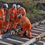 Workers constructing railway tracks.