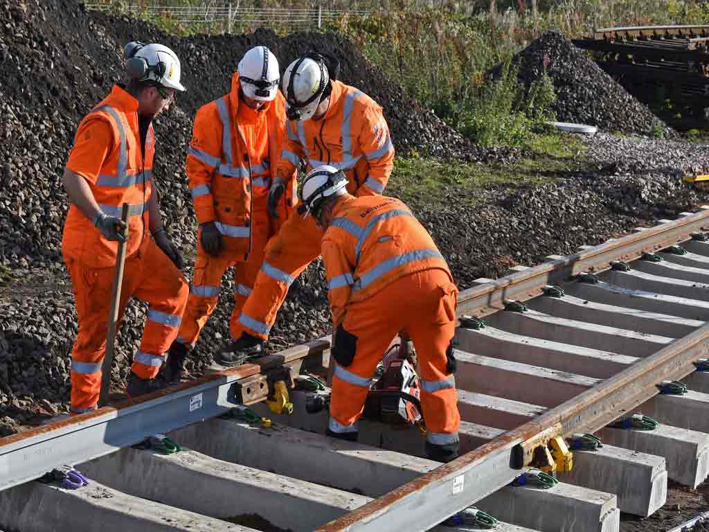 Workers constructing railway tracks.