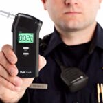 A police officer showing the results of a breathalyser test