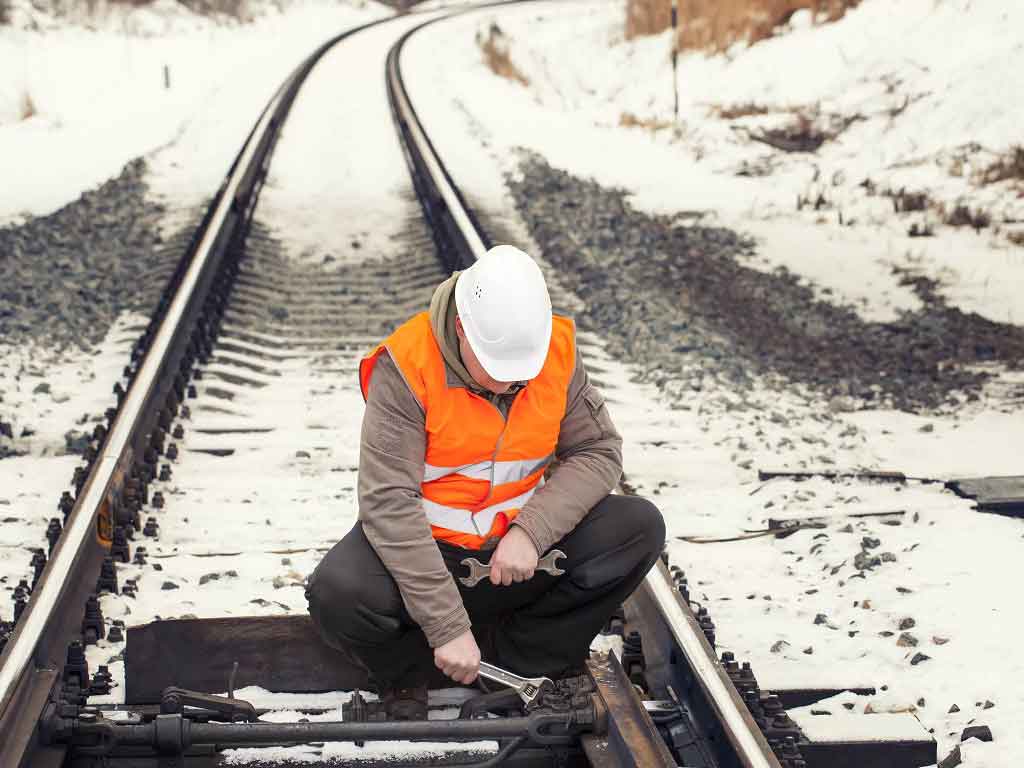 A railway worker fixing the track 