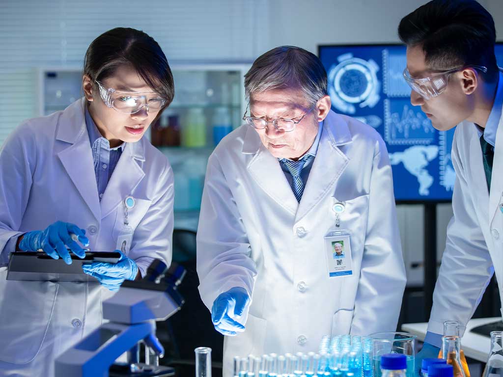 Three professionals conducting laboratory tests