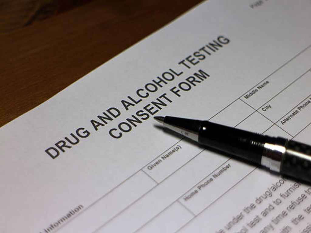 Drug and alcohol testing consent form and a pen