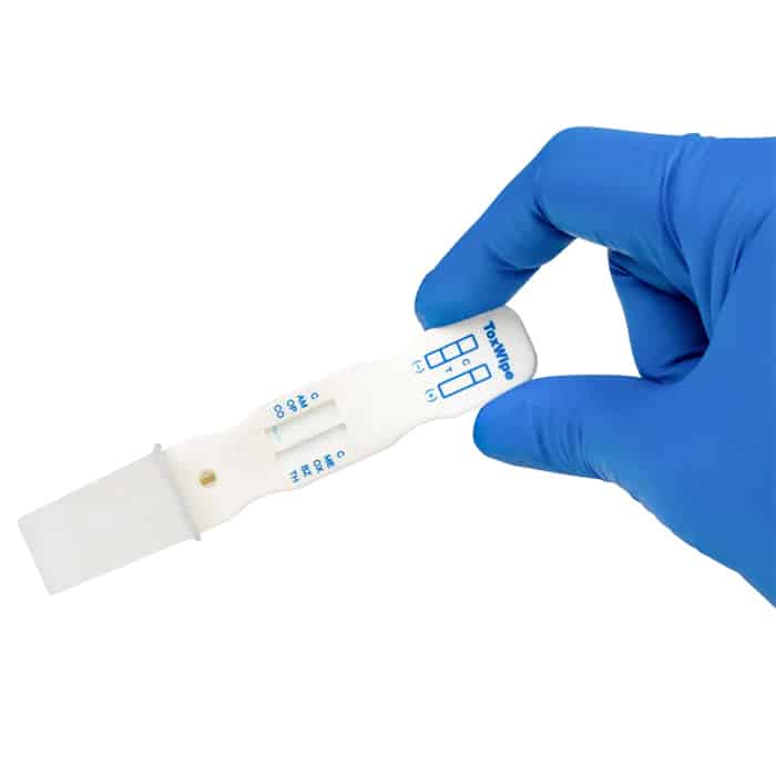 A gloved hand showing a Toxwipe 7 test