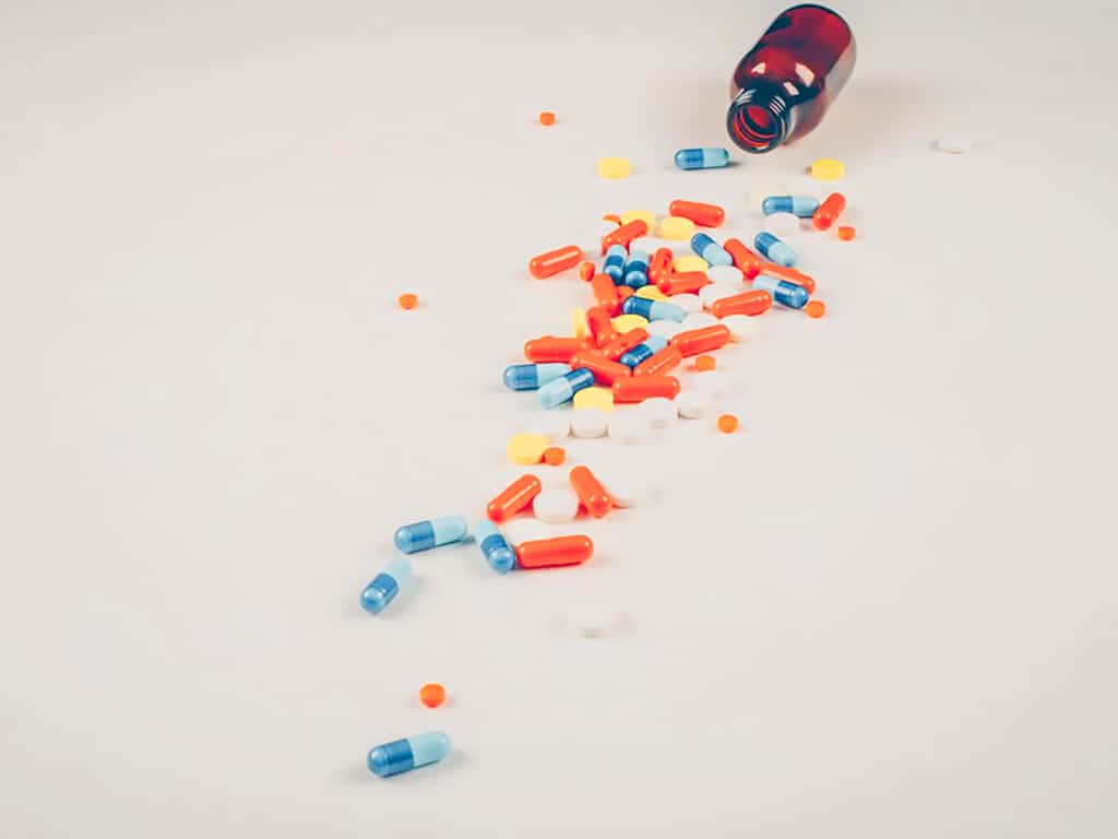 Pills and medicines scattered on the surface in various colours