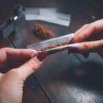 A person rolling a cannabis blunt