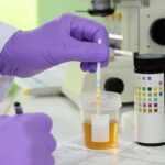 A lab professional analysing urine samples
