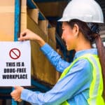 A lady engineer posting a drug-free workplace sign