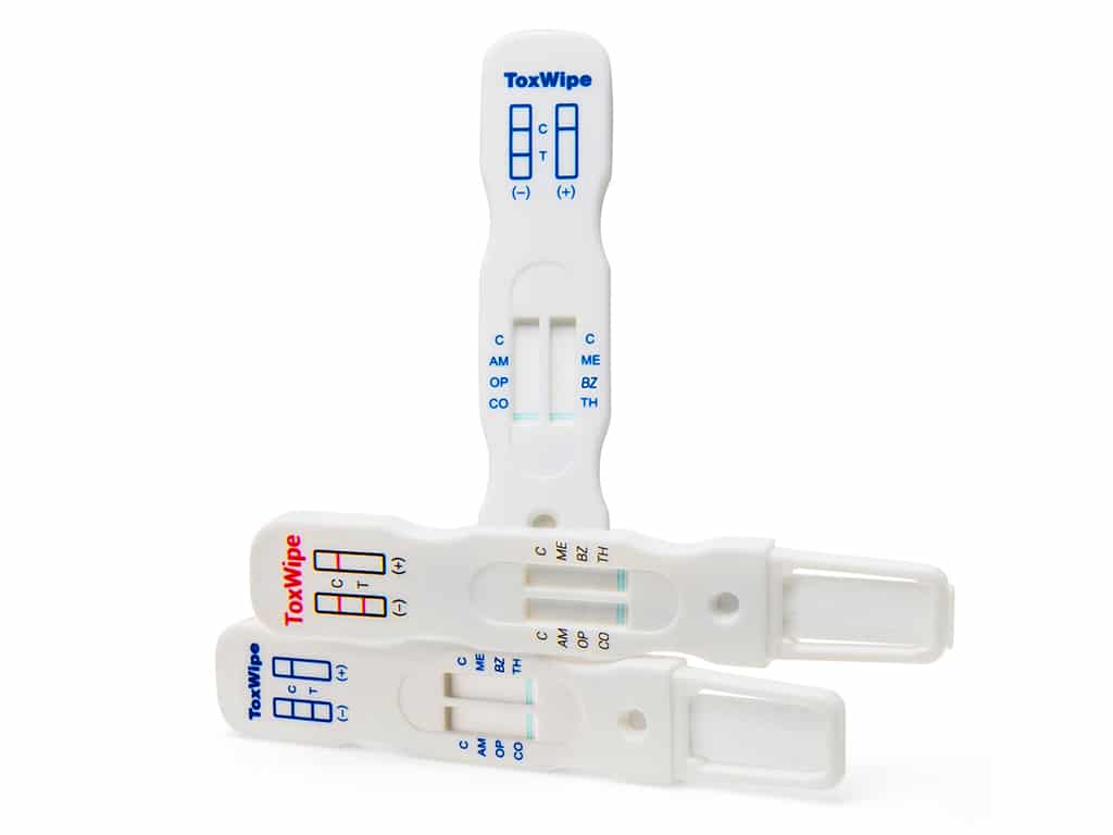 Three pieces of ToxWipe saliva drug test kits